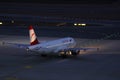 Austrian Airlines plane taxiing, night light Royalty Free Stock Photo