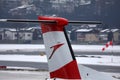 Austrian Airlines plane taxiing in Innsbruck Airport, INN snow in winter, close-up view Royalty Free Stock Photo