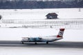 Austrian Airlines plane taxiing in Innsbruck Airport, INN snow in winter Royalty Free Stock Photo