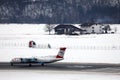 Austrian Airlines plane taxiing in Innsbruck Airport, INN snow in winter Royalty Free Stock Photo