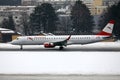 Austrian Airlines plane taxiing in Innsbruck Airport, INN snow in winter Royalty Free Stock Photo