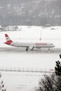 Austrian Airlines small jet on the snowy runway, Innsbruck Airport INN Royalty Free Stock Photo