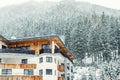 Austrian alpine village scenic landscape with small chalet and pine forest trees and snow covered mountains on background during Royalty Free Stock Photo