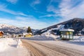 Snowy road, snow covered bus stop with mountain at the background. Ski region Schladming, Liezen, Styria, Austria, Europe