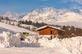 Austrian bus and wooden house. Mountains at the background. Ski region Schladming-Dachstein, Liezen, Styria, Austria Royalty Free Stock Photo