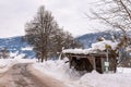 Old, wooden, snow-covered bus stop. Mountains,ski region Schladming-Dachstein, Dachstein massif, Ortner, Liezen, Styria, Austria