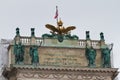 Austrian coat of arms - golden eagle with crown, national flag and sculptures on top of Hofburg Neue Burg, Heldenplatz