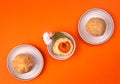 Austrian and czech sweet dessert apricot dumplings on orange background. Filled cottage cheese dough. top view