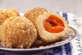 Austrian and czech sweet dessert knedle apricot dumplings on fabric with ornament background. Filled cottage cheese dough. close