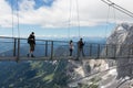 Austrian Dachstein Mountains with hikers passing a skywalk rope Royalty Free Stock Photo