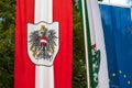 Austrian flag with coat of arms develops in the wind