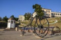 Austrian large iron bicycle monument, flower clock on square of Saint Maria ( Turkish square) with Turkish well Royalty Free Stock Photo