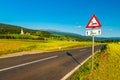 An Austrian rural landscape with an empty road between agricultural fields leading to the Alps Royalty Free Stock Photo