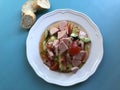 Austrian sausage salad `Wurstsalat` is a traditional snack and a light summer dish