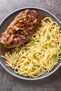 Austrian Steak Zwiebelrostbraten With Crispy Onions and spaetzle pasta closeup on the plate. Vertical top view Royalty Free Stock Photo