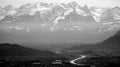 Austrian and Swiss mountains with snow and hilly small town in black and white Royalty Free Stock Photo