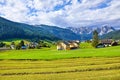 Austrian village among meadows fields and Alpine Royalty Free Stock Photo