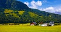 Austrian village among meadows fields and Alpine Royalty Free Stock Photo