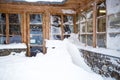 Austrian wooden house with big windows covered by snow at snowstorm Royalty Free Stock Photo