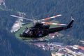 Austrian working helicopter captured in the sky touring mountains