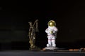 Austronaut keeps earth in his hands close to the statue of Themis Royalty Free Stock Photo