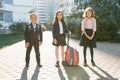 Outdoor portrait of smiling schoolchildren in elementary school. A group of kids with backpacks are having fun, talking. Education Royalty Free Stock Photo