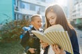 Outdoor portrait of smiling schoolchildren in elementary school. A group of kids with backpacks are having fun, talking. Education Royalty Free Stock Photo