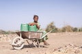 Authentic African ethnic Young Girl Collecting fresh Water as a drought symbol