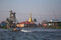 Authentic boat floats amid the golden pagoda in Myanmar Royalty Free Stock Photo