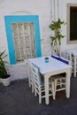 Authentic Bodrum Streets by the Sea. Blue window, white tables street traditional Turkish Bodrum cafe. Cozy outdoor cafe Royalty Free Stock Photo