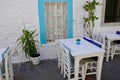 Authentic Bodrum Streets by the Sea. Blue window, white tables street traditional Turkish Bodrum cafe. Cozy outdoor cafe Royalty Free Stock Photo