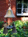 Authentic brass doorbell against the backdrop of a red brick wall and bushes of greenery