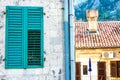 Texture of stone wall with part of wooden green shutters, background Royalty Free Stock Photo