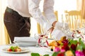Preparing for a banquet. Waiter places glasses on a banquet table. The feast begins Royalty Free Stock Photo