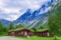 Authentic cabins with green grass on the roof at the foot of the popular Troll Stair or Trollstigen serpentine road