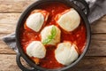 Authentic chicken pizzaiola is made with just 4 main ingredients chicken, tomato puree, basil and mozzarella closeup on the pan.