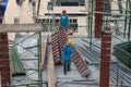 Authentic construction worker busy on the positioning of formwork frames in construction site