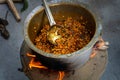Authentic dal tadka prepared outdoors in India using clay pot and firewood in traditional style Royalty Free Stock Photo