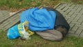 OLOMOUC, CZECH REPUBLIC, JANUARY 2, 2019: Authentic emotion homeless man senior asleep and sleep in sleeping bag on