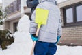 Authentic family winter fun. Family building a snowman in their frontyard. Candid real people lifestyle image.