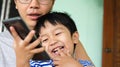 Authentic father and son looking on smartphone outdoor with happy smiling face. Dad and child have happy moment together. Royalty Free Stock Photo