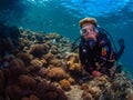 Lady diver with school of diamondfish