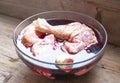 Authentic French recipe in wine stew or coq au vin. Raw fresh uncooked chicken hen, fowl, cock, bird parts slices close up