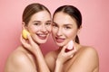 Authentic glow. Makeup-free magic and mutual glam. Portrait of two attractive girls, friends looking at camera and