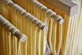 Handmade Fresh Pasta Drying on Wooden Rack Dryer. Italy Aesthetic. Royalty Free Stock Photo