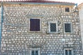 Authentic house with a stone wall and a beautiful green door and with a beautiful stone bench at the entrance