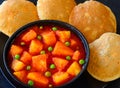 Authentic Indian fluffy bread poori with spicy potato peas gravy Royalty Free Stock Photo