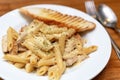 Authentic Italian creamy chicken Alfredo penne pasta in a restaurant closeup