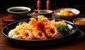 Authentic Japanese cuisine tempura shrimp with traditional sides and dipping sauce served on a ceramic plate Royalty Free Stock Photo