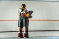 Authentic lady with bob haircut lying on the treadmill with basketball ball